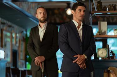 M.I.A. -- "Faultlines" Episode 106 -- Pictured: Alberto Guerra as Elias -- (Photo by: Jeff Daly/PEACOCK)