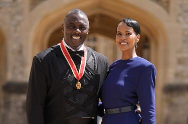 British actor Idris Elba poses with his wife Sabrina Dhowre Elba and his medal after being appointed as a Knight Bachelor (Knighthood) for services to young people at an investiture ceremony at Windsor Castle on June 2, 2026. (Photo by Andrew Matthews / POOL / AFP)