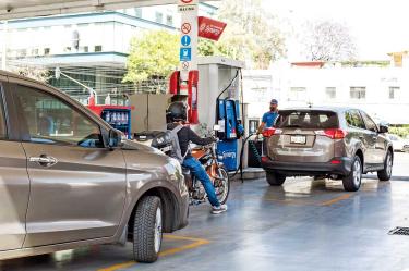 Automovilistas y motociclista cargando gasolina en México.