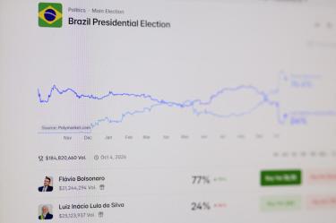 This photograph shows computer screens displaying the website of US-based cryptocurrency prediction market platform Polymarket in Rio de Janeiro, Brazil on October 16, 2026. Although banned in Brazil, Polymarket has emerged as an unexpected player in the presidential election campaign, used mainly by right-wing supporters as a credible indicator of voter sentiment amid growing distrust of traditional opinion polls. (Photo by Pablo PORCIUNCULA / AFP)