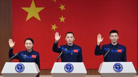 Astronauts for China's Shenzhou-23 space mission Lai Ka-ying (L), Zhu Yangzhu (C) and Zhang Zhiyuan (R) wave during a press conference before the launch of the mission at the Jiuquan Satellite Launch Center in the Gobi desert in Jiuquan, in northwestern China's Gansu province on May 23, 2026. (Photo by CNS / AFP) / China OUT